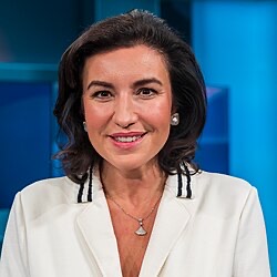 Dorothee Bär smiling in a television studio, wearing a white jacket